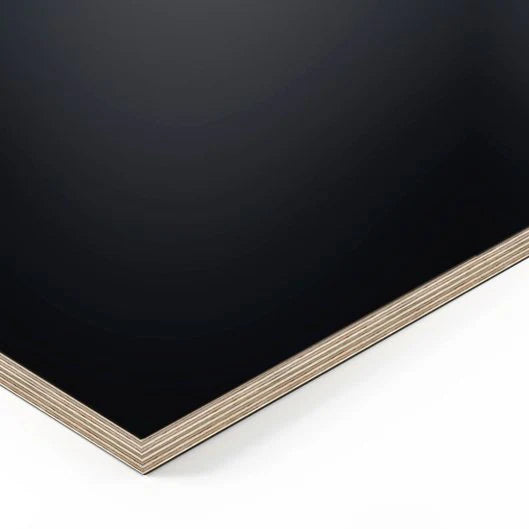 A close-up of the rectangular Tischplatte - Multiplex Fenix Nero with a smooth, matte FENIX NTM surface and visible layered edges, set against a white background.