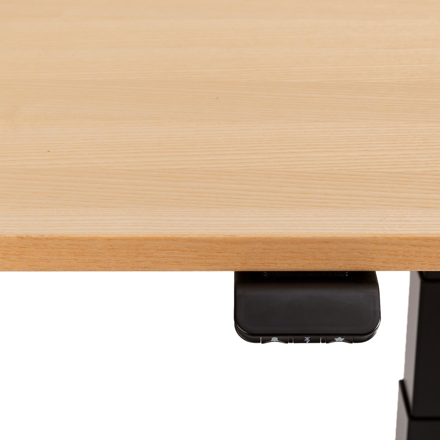 Close-up of the FLEX desk in light wood, featuring a black plug-and-play electronic control panel under the edge for quick height adjustments—perfect for any home office.