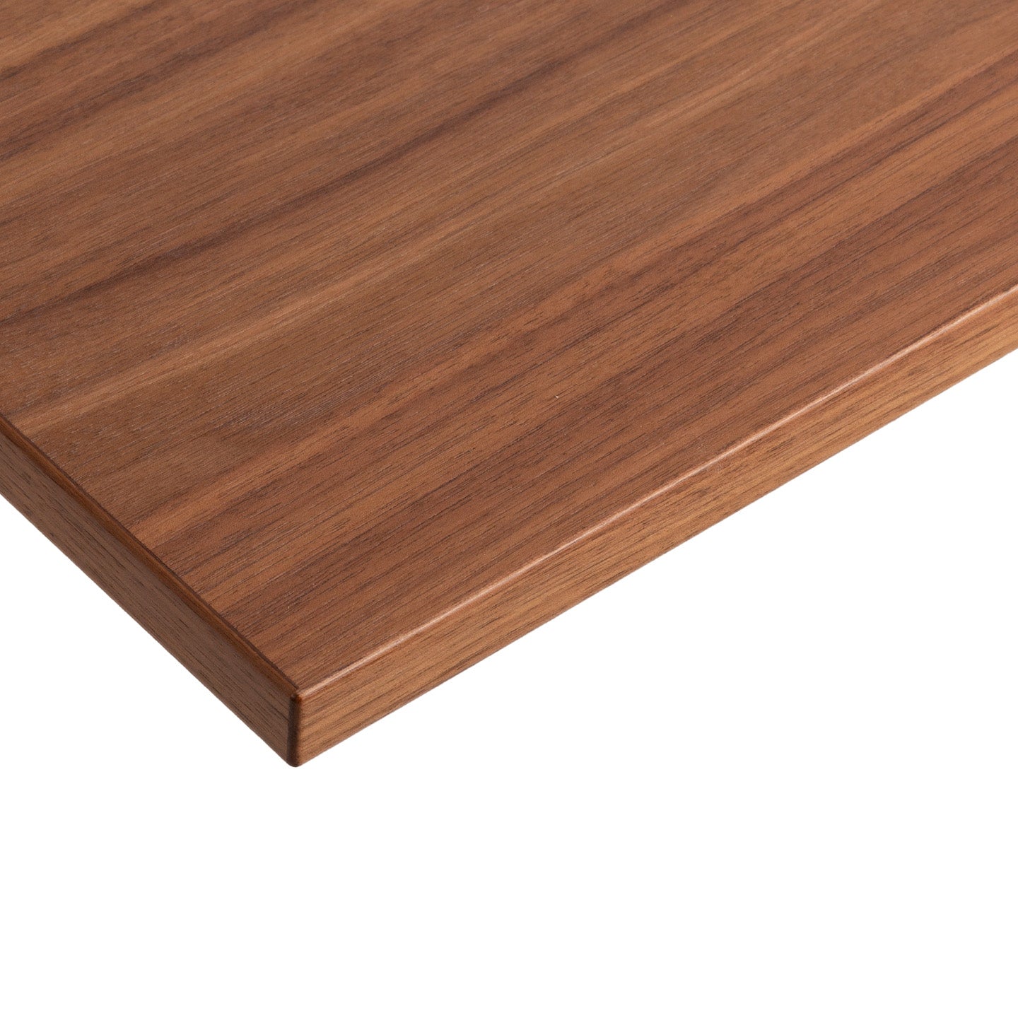 A close-up of the corner of the Tischplatte - Furnier Walnuss, made in Germany, showcasing its smooth, polished surface and visible walnut wood grain patterns against a white background.