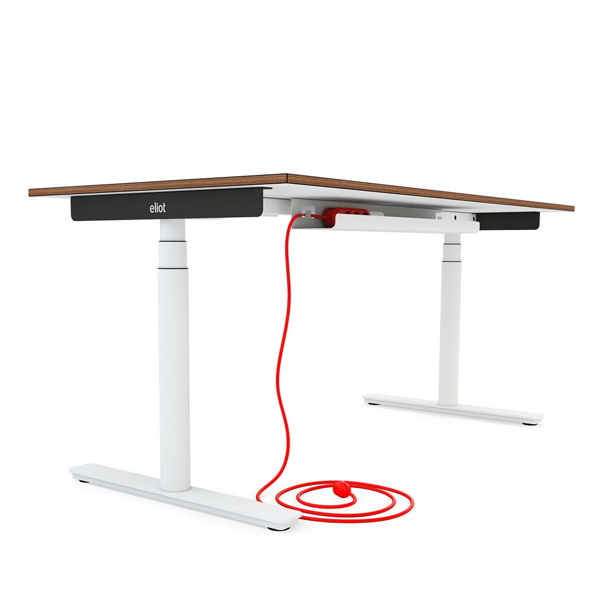 A modern height-adjustable desk with a dark wood tabletop, white metal legs, and a visible red power cord coiled beneath, organized by the Kabelwanne - 1 Cable Light EU cable management system and plugged into an underside power strip.
