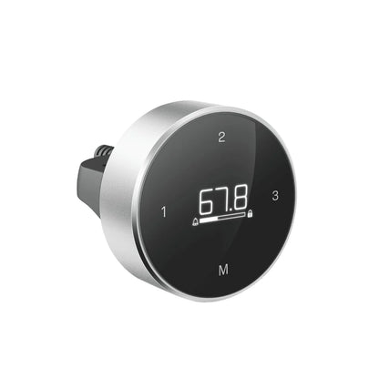 The Smartcontroller - Eliot is a round controller with silver edges, a black display showing 67.8, buttons labeled 1, 2, 3, and M, and a rear plug—perfect for any höhenverstellbarer Schreibtisch.