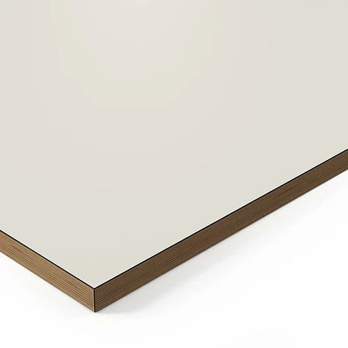 A close-up of the corner of the Tischplatte - Design White, a rectangular board with a smooth light beige surface, brown wood-grain edge, and Melamin Beschichtung. Made in Germany.