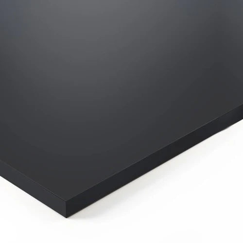 A close-up of the elegant Tischplatte - Soft Graphite, featuring a smooth, matte black surface with sharp edges and Sense-Touch Oberfläche, placed on a white background.